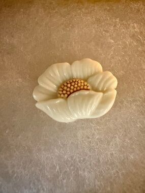 A finely carved shell or bone magnolia flower brooch